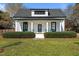 Charming home featuring a cozy front porch with decorative shrubs and inviting curb appeal at 1310 S 8Th St, Lillington, NC 27546