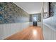 Charming hallway with eye-catching wallpaper, wainscoting, and hardwood floors at 1310 S 8Th St, Lillington, NC 27546