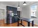 Eat-in kitchen featuring stainless steel appliances, dark cabinets, hardwood floors and a large window at 1310 S 8Th St, Lillington, NC 27546