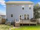 Two-story home features a wooden deck, back door, and well-maintained lawn at 1515 E Jones St, Raleigh, NC 27610