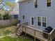 Backyard featuring a wooden deck with stairs leading down to the grassy area and a grill at 1515 E Jones St, Raleigh, NC 27610