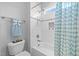 Bright bathroom with white subway tile in shower, along with blue shower curtain and towel at 1515 E Jones St, Raleigh, NC 27610