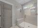 Modern bathroom features a glass-enclosed shower with gray subway tile, bench seating, and a gray door at 1515 E Jones St, Raleigh, NC 27610