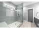 Modern bathroom features a glass-enclosed shower with gray subway tile, bench seating, and a gray door at 1515 E Jones St, Raleigh, NC 27610