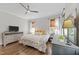 Bedroom features neutral walls, hardwood floors, and windows with woven shades at 1515 E Jones St, Raleigh, NC 27610