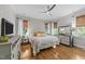 Bedroom with hardwood floors, neutral walls, and windows with woven shades at 1515 E Jones St, Raleigh, NC 27610