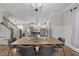 Elegant dining area with modern chandelier, hardwood floors, and open access to the living room at 1515 E Jones St, Raleigh, NC 27610