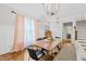 Elegant dining area with modern chandelier, hardwood floors, and natural light at 1515 E Jones St, Raleigh, NC 27610