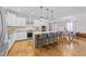 Bright kitchen featuring a large center island, stainless steel appliances, and white cabinetry at 1515 E Jones St, Raleigh, NC 27610