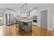 Bright kitchen featuring a large center island, stainless steel appliances, and white cabinetry at 1515 E Jones St, Raleigh, NC 27610