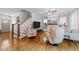 Cozy living room with hardwood floors, a fireplace, and stairs to the second floor at 1515 E Jones St, Raleigh, NC 27610