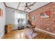 Charming office space featuring exposed brick wall, hardwood floors, and ceiling fan at 1515 E Jones St, Raleigh, NC 27610