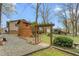 Landscaped backyard with garden beds, mature trees, and a two-story playhouse at 1525 Rogers Rd, Graham, NC 27253
