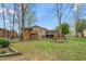 Spacious backyard with a two-level deck, a patio and a playhouse visible at 1525 Rogers Rd, Graham, NC 27253