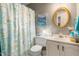 Cozy bathroom featuring a vanity, decorative mirror, and a shower with a themed curtain at 1525 Rogers Rd, Graham, NC 27253