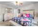 Cozy bedroom features a ceiling fan, neutral walls, and a light wood dresser at 1525 Rogers Rd, Graham, NC 27253