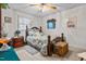 Bedroom features a wood-frame bed, carpet floors, and natural lighting from the window at 1525 Rogers Rd, Graham, NC 27253