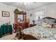 Cozy bedroom featuring a wood dresser, vintage decor, and a comfortable bed with decorative linens at 1525 Rogers Rd, Graham, NC 27253