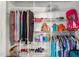 Walk-in closet with wire shelving, filled with clothes, purses, and shoes at 1525 Rogers Rd, Graham, NC 27253