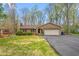 Charming brick home with attached garage and well-maintained lawn and paved driveway at 1525 Rogers Rd, Graham, NC 27253