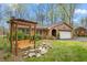 Charming brick home with an inviting front yard featuring a wooden swing and stone accents at 1525 Rogers Rd, Graham, NC 27253