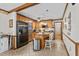 Traditional kitchen boasts wooden cabinetry, tile floors, an island with seating, and stainless steel appliances at 1525 Rogers Rd, Graham, NC 27253