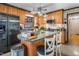 Traditional kitchen featuring central island with bar seating, wood cabinetry, stainless appliances and tile flooring at 1525 Rogers Rd, Graham, NC 27253
