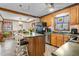 A sunlit kitchen is complemented by an adjacent dining area, wood cabinets, and a convenient island with seating at 1525 Rogers Rd, Graham, NC 27253
