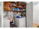 A laundry room provides lots of shelving for storage with included washer and dryer units at 1525 Rogers Rd, Graham, NC 27253