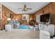 Spacious living room featuring cozy wood-paneled walls and comfortable seating for relaxing and entertaining at 1525 Rogers Rd, Graham, NC 27253