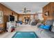 Spacious living room with wood-paneled walls and a cozy brick fireplace, ready for relaxation at 1525 Rogers Rd, Graham, NC 27253