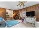 Cozy living room features wood-paneled walls and an inviting step-down area, perfect for relaxing at 1525 Rogers Rd, Graham, NC 27253