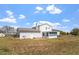 Expansive backyard showcasing a white two-story home with an enclosed porch and spacious lawn at 153 Glenn Oak Dr, Sanford, NC 27332
