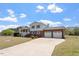 Exterior showcasing a two-story home with a well-maintained lawn, brick accents, and a two-car garage at 153 Glenn Oak Dr, Sanford, NC 27332