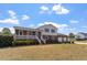 View of the home's exterior, featuring a two-story brick facade, porch, and large front yard at 153 Glenn Oak Dr, Sanford, NC 27332