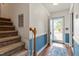 Entryway featuring a staircase, wood flooring, and an inviting blue accent wall at 153 Glenn Oak Dr, Sanford, NC 27332