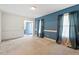 Inviting living room with blue walls, large windows, and neutral carpeting at 153 Glenn Oak Dr, Sanford, NC 27332