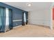 Bright living room with neutral carpet, wainscotting, and serene blue accent wall at 153 Glenn Oak Dr, Sanford, NC 27332