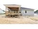 Back view of new home featuring a covered wood deck and gray vinyl siding at 1547 Pecan Drive # 31, Nashville, NC 27856
