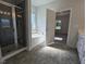 Bathroom featuring tiled floors, a walk-in shower with glass door, and soaker tub at 1547 Pecan Drive # 31, Nashville, NC 27856