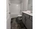 A bathroom with tiled floors, a tub and shower combo, and a gray vanity at 1547 Pecan Drive # 31, Nashville, NC 27856