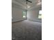 A spacious bedroom with large windows, carpet floors, a ceiling fan and recessed lighting at 1547 Pecan Drive # 31, Nashville, NC 27856