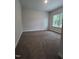An open bedroom with carpet flooring and a window for natural light at 1547 Pecan Drive # 31, Nashville, NC 27856