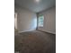 An open, carpeted bedroom with a window for plenty of natural light at 1547 Pecan Drive # 31, Nashville, NC 27856