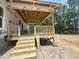 New deck under construction with wooden stairs and railing, nestled amongst mature trees at 1547 Pecan Drive # 31, Nashville, NC 27856