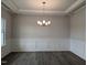 Elegant dining room showcasing wainscoting, wood floors, and a stylish chandelier at 1547 Pecan Drive # 31, Nashville, NC 27856