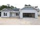 New construction home featuring light gray siding, black roof, and an attached two car garage at 1547 Pecan Drive # 31, Nashville, NC 27856