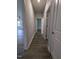 Hallway with hardwood style floors leading into rooms with white trim and neutral paint at 1547 Pecan Drive # 31, Nashville, NC 27856