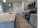 Modern kitchen featuring gray cabinets, granite countertops, stainless steel appliances and a large sink at 1547 Pecan Drive # 31, Nashville, NC 27856