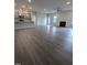 Open-concept living room, featuring wood floors, gray cabinets, a kitchen island, and fireplace at 1547 Pecan Drive # 31, Nashville, NC 27856